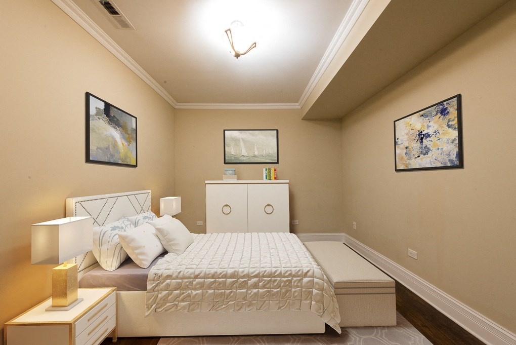 a bedroom with a bed and a dresser and a window