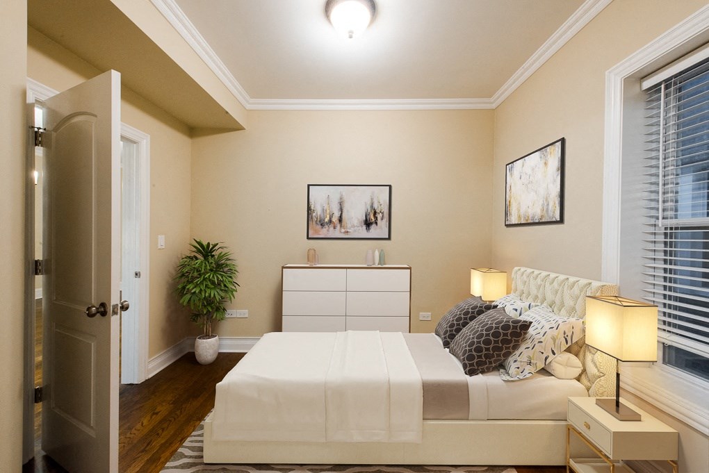 a bedroom with a bed and a dresser and a window