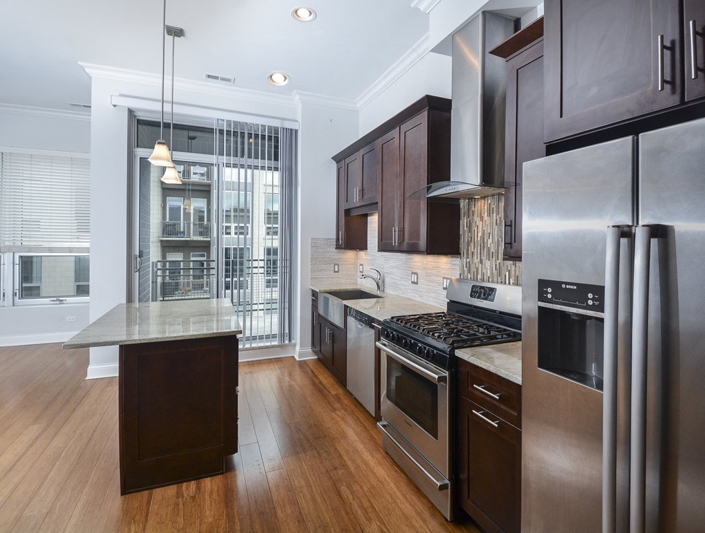 a kitchen with stainless steel appliances and a large island