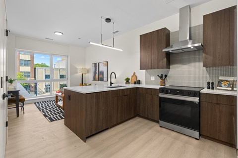 A modern kitchen with wooden cabinets and a large island.