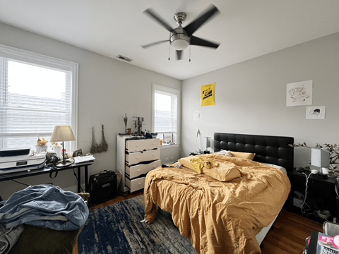 a bedroom with a bed and a ceiling fan