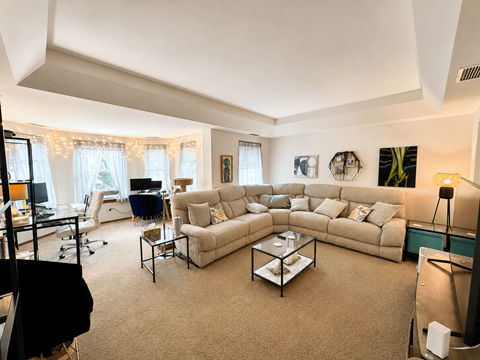 A living room with a large couch and a coffee table.
