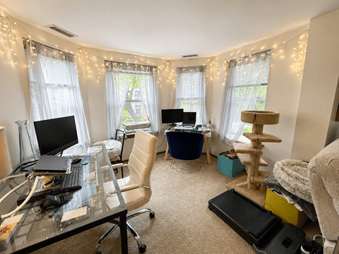 A home office with a desk, chair, and computer.