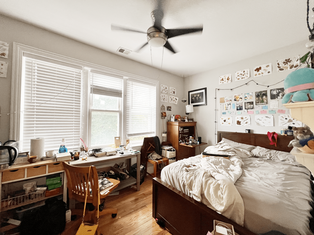 a bedroom with a bed and a ceiling fan