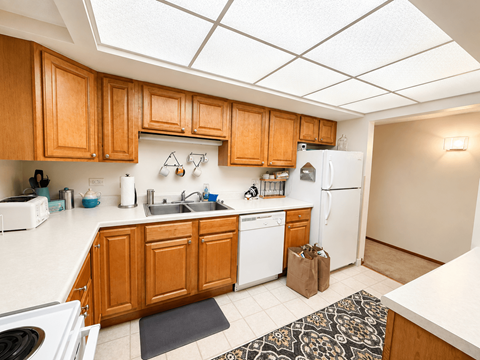 A kitchen with wooden cabinets and white appliances.