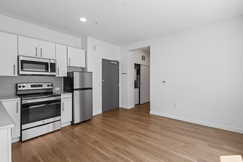 A kitchen with white cabinets and stainless steel appliances.