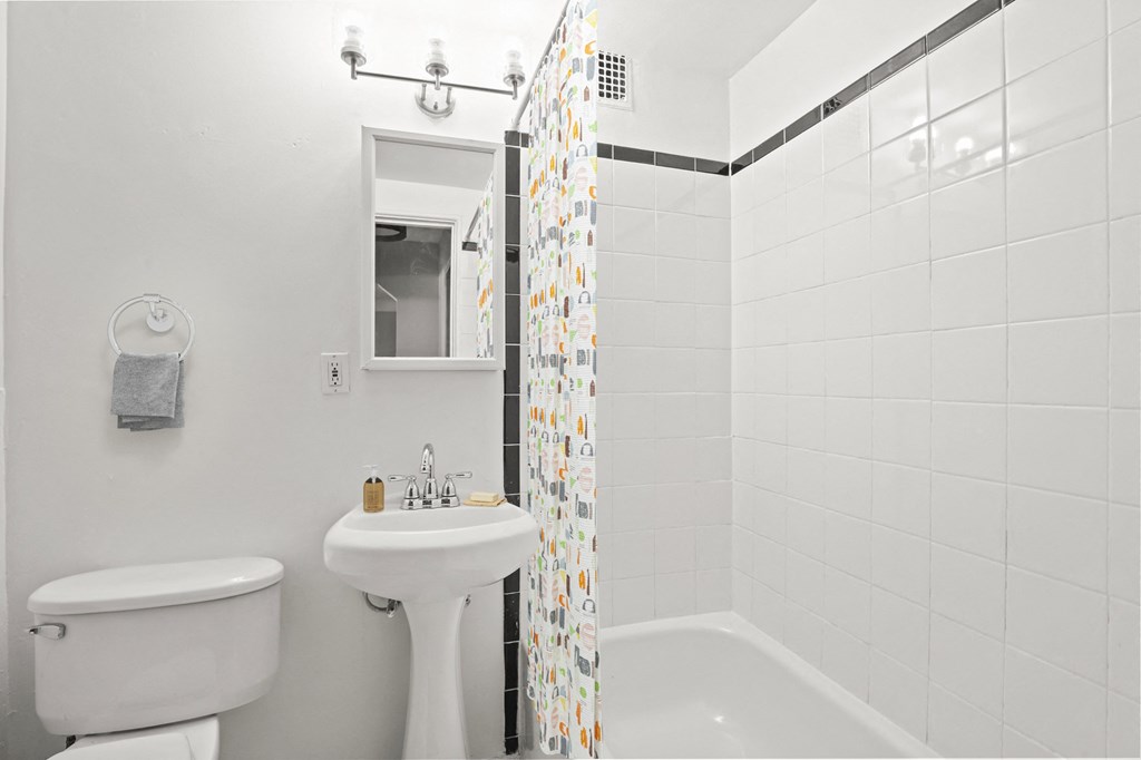 a bathroom with a sink toilet and a shower curtain