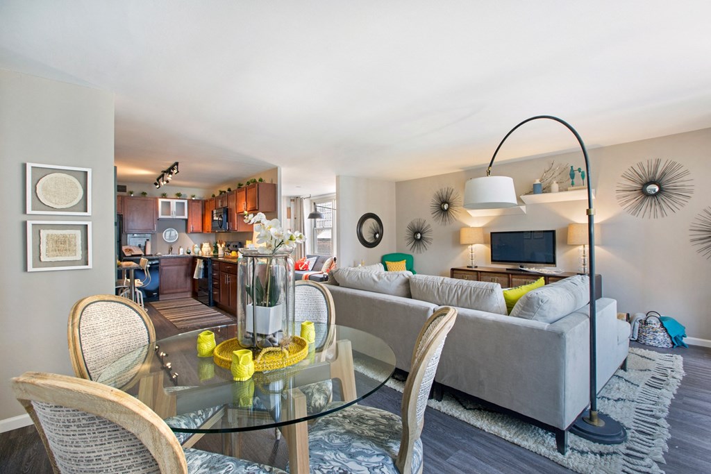 a living room with a glass table and a couch