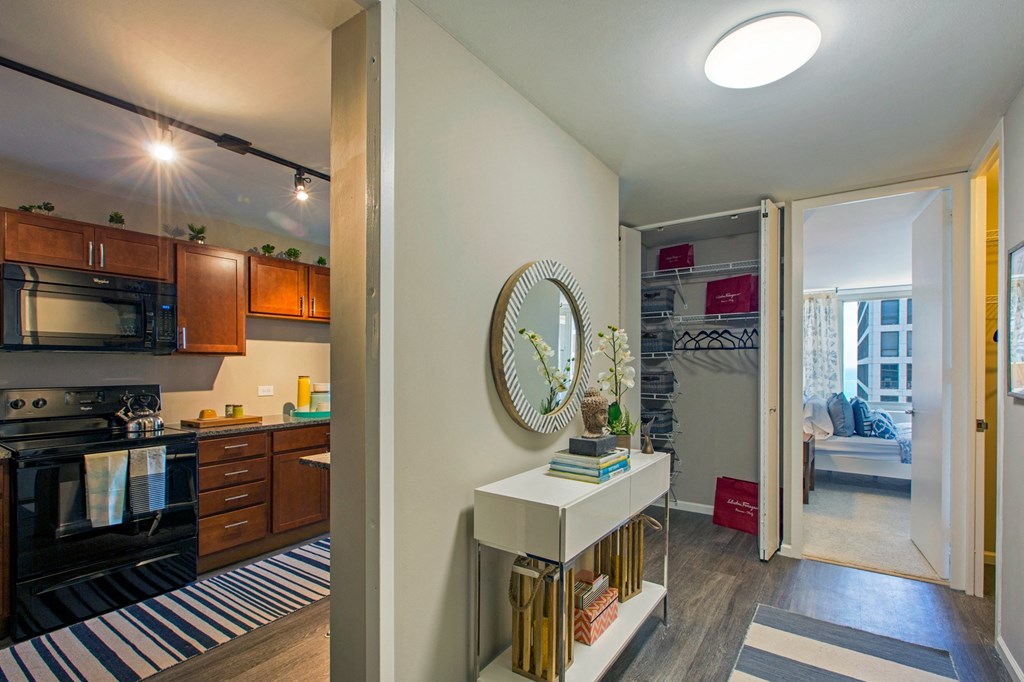 a view of a kitchen and a living room with a door open to a hallway