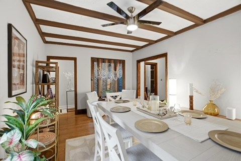 A dining room with a long table set for a meal.