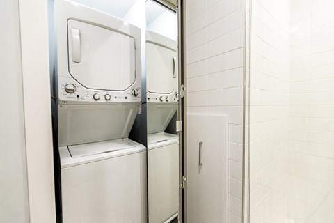 A row of washing machines in a public laundromat.