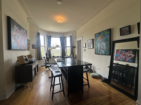 A room with a table and chairs in it.