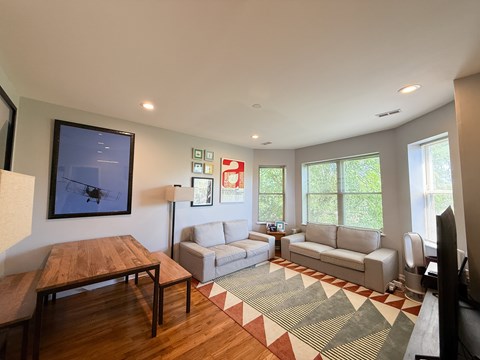 A living room with a wooden table and a couch.