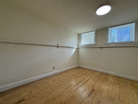 A room with wooden flooring and a window.