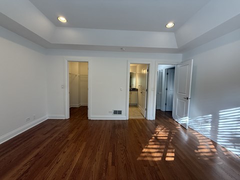 A room with wooden floors and white walls.