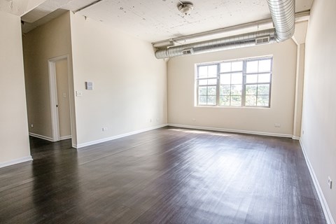 A room with wooden floors and a window.