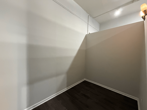 A corner of a room with a light on.