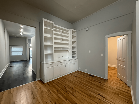 A room with wooden floors and white walls.