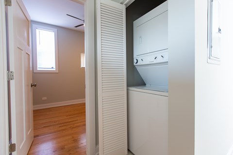 A white oven is in a kitchen with a wooden floor.
