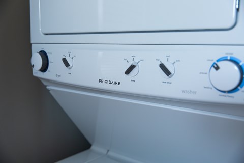 A white washing machine with the control panel showing.