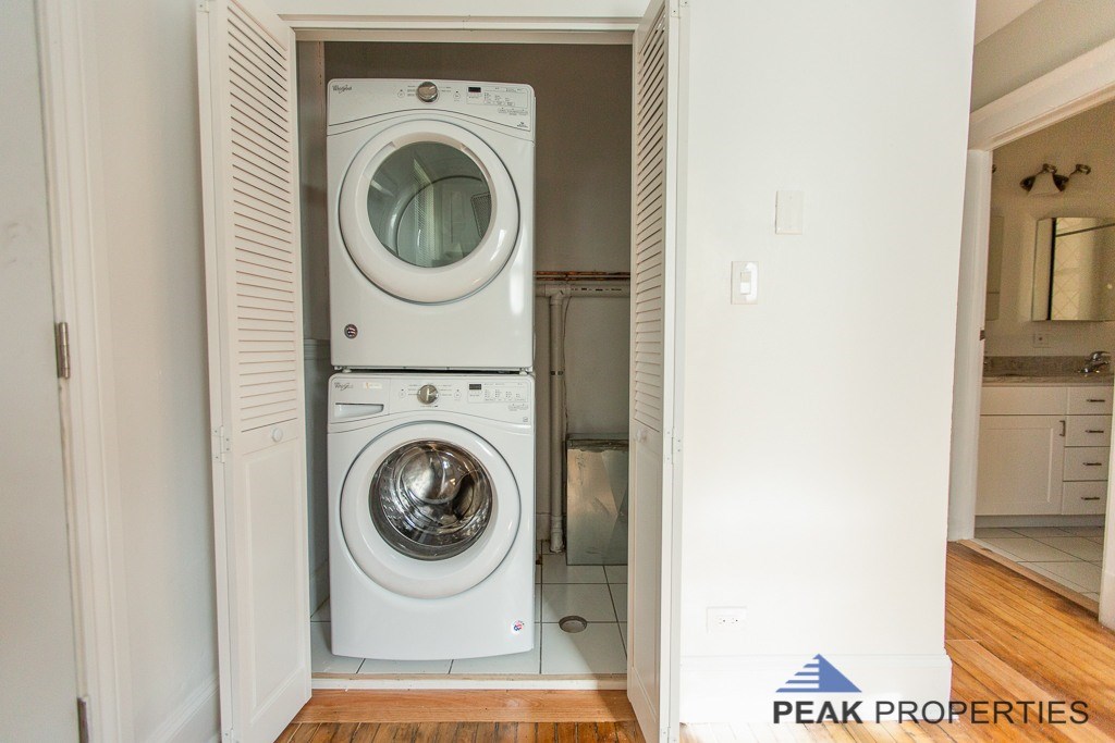 A white washing machine and dryer in a small laundry room.