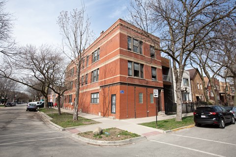 A red brick building with a blue sign on the front.