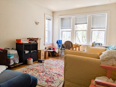 a living room filled with furniture and a window