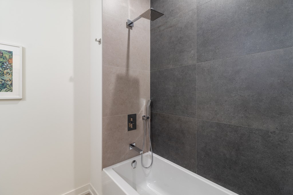 a small bathroom with a shower and a bath tub