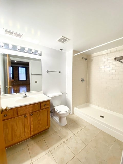 A white bathroom with a toilet, sink, and bathtub.
