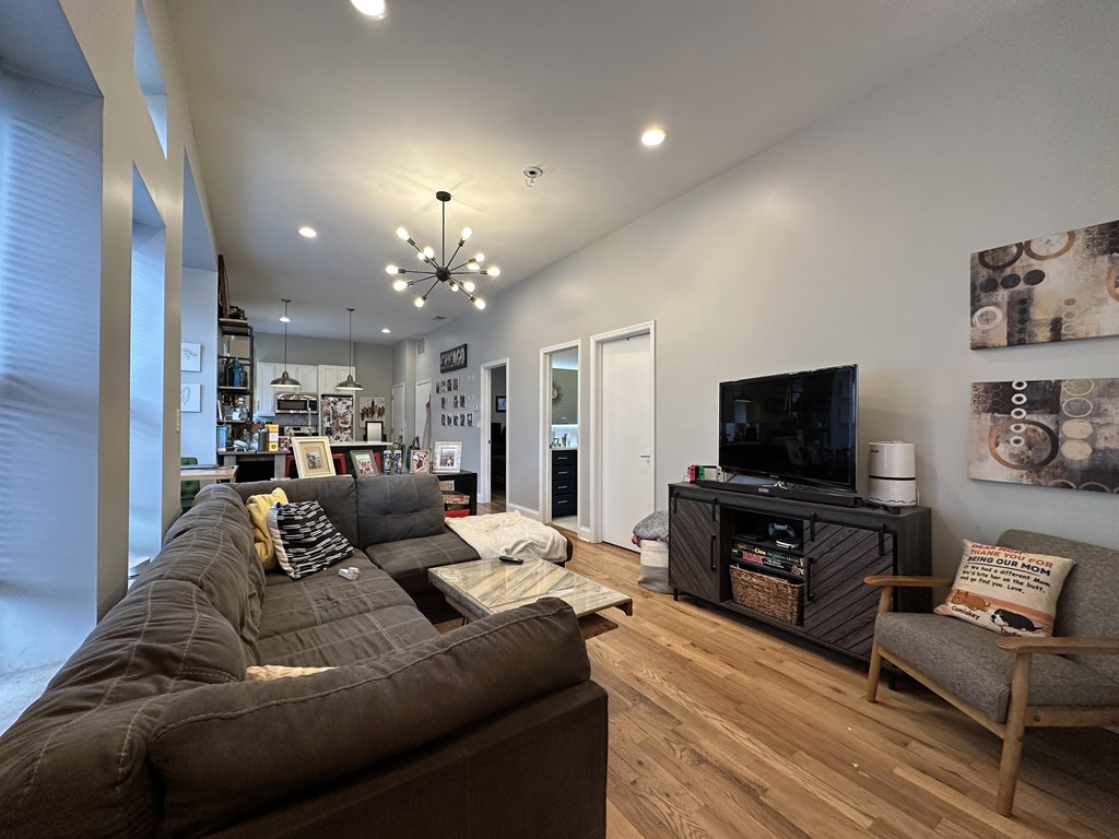 A living room with a brown couch and a television.