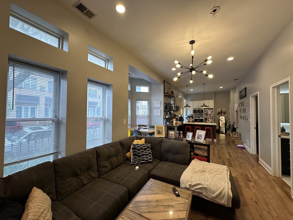 A living room with a large sectional sofa and a coffee table.