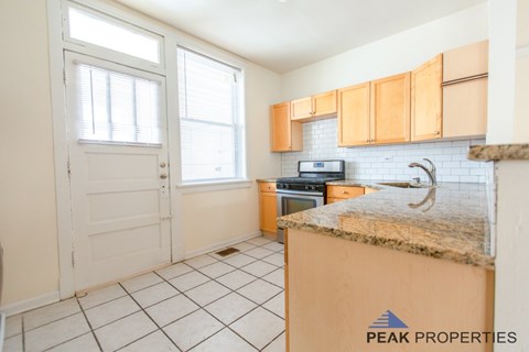 A kitchen with a counter top and cabinets.