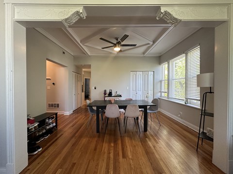 A dining room with a table and chairs.