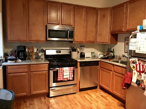 a kitchen with wooden cabinets and stainless steel appliances