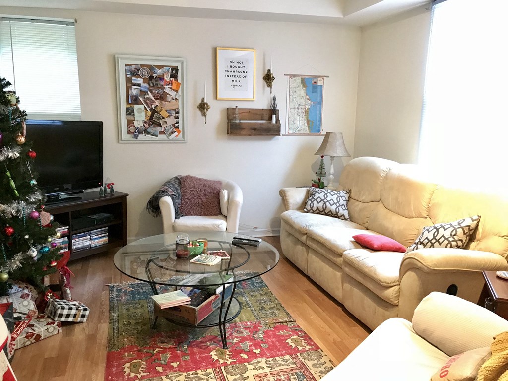 a living room filled with furniture and a christmas tree