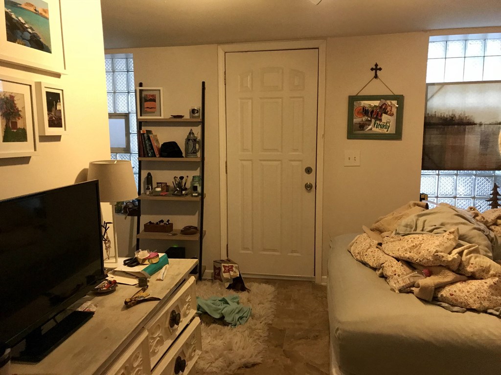 a living room with a bed and a tv