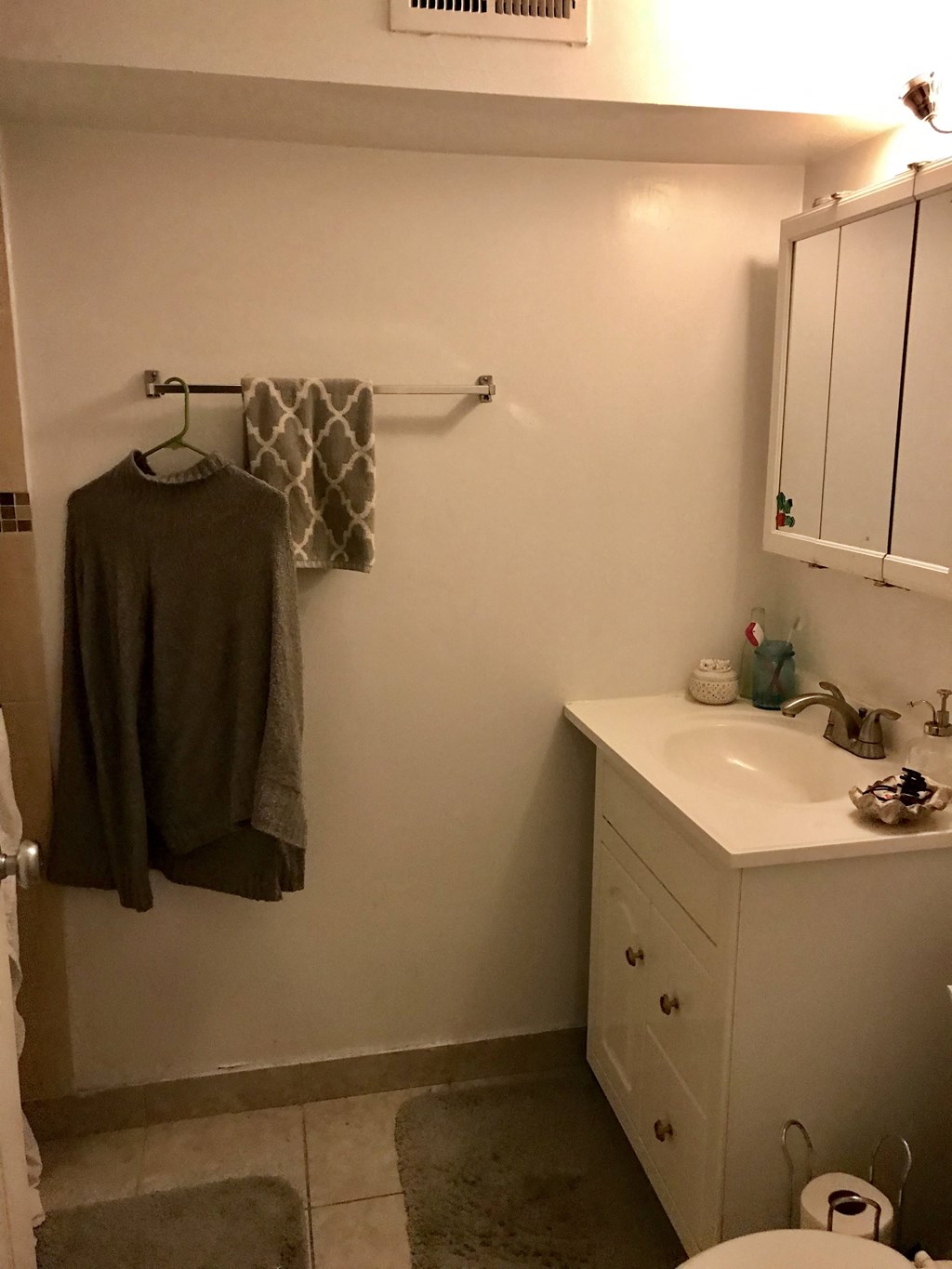 a small bathroom with a sink and a towel rack