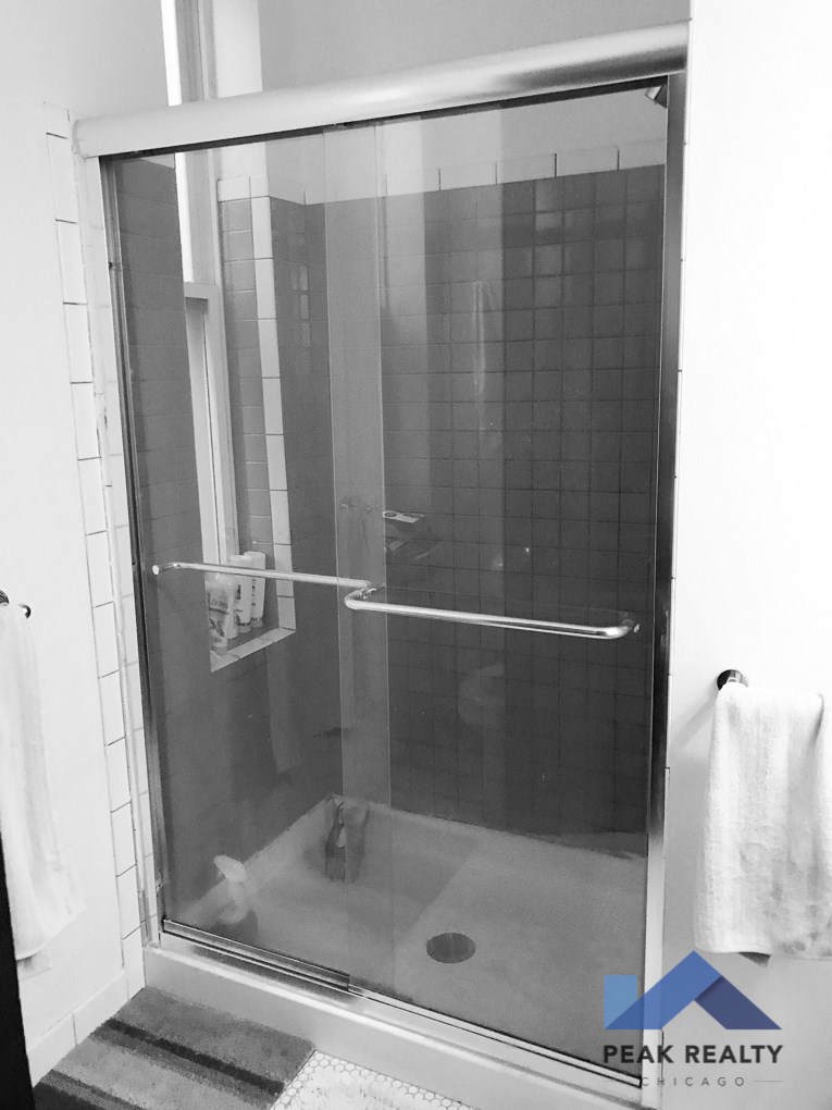 a walk in shower with a glass door