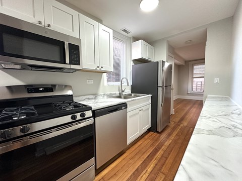 A kitchen with a stove, oven, and refrigerator.