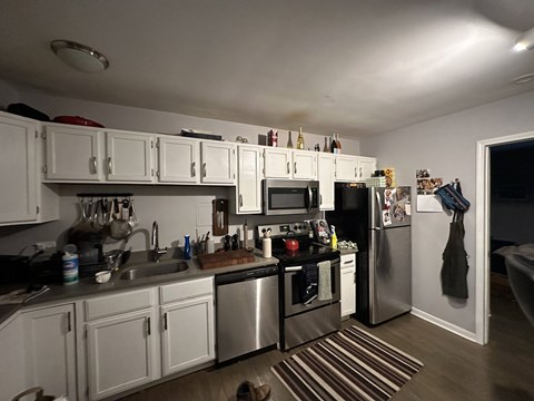 A kitchen with white cabinets and stainless steel appliances.