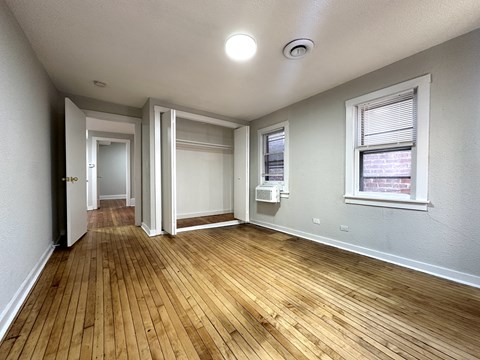 A room with wooden floors and white walls.