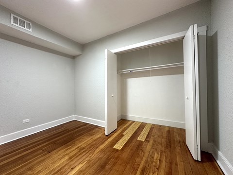 A room with a wooden floor and a white door.