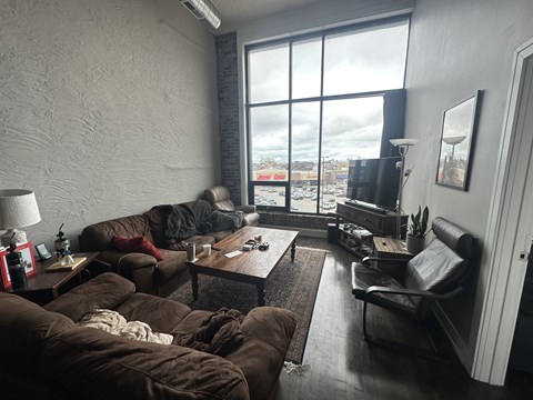 A living room with a couch, chair, and coffee table.