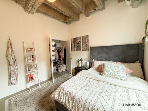 A bedroom with a large bed and a wardrobe.