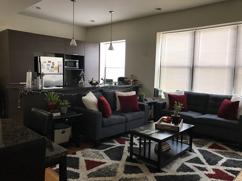 A modern living room with a black couch and a black coffee table.