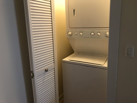 A white oven with a door open is in a room with a white door to the left.