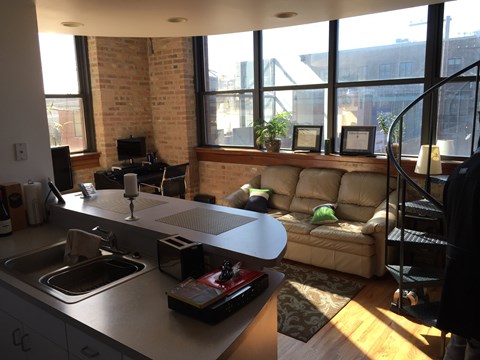A kitchen with a couch and a table.