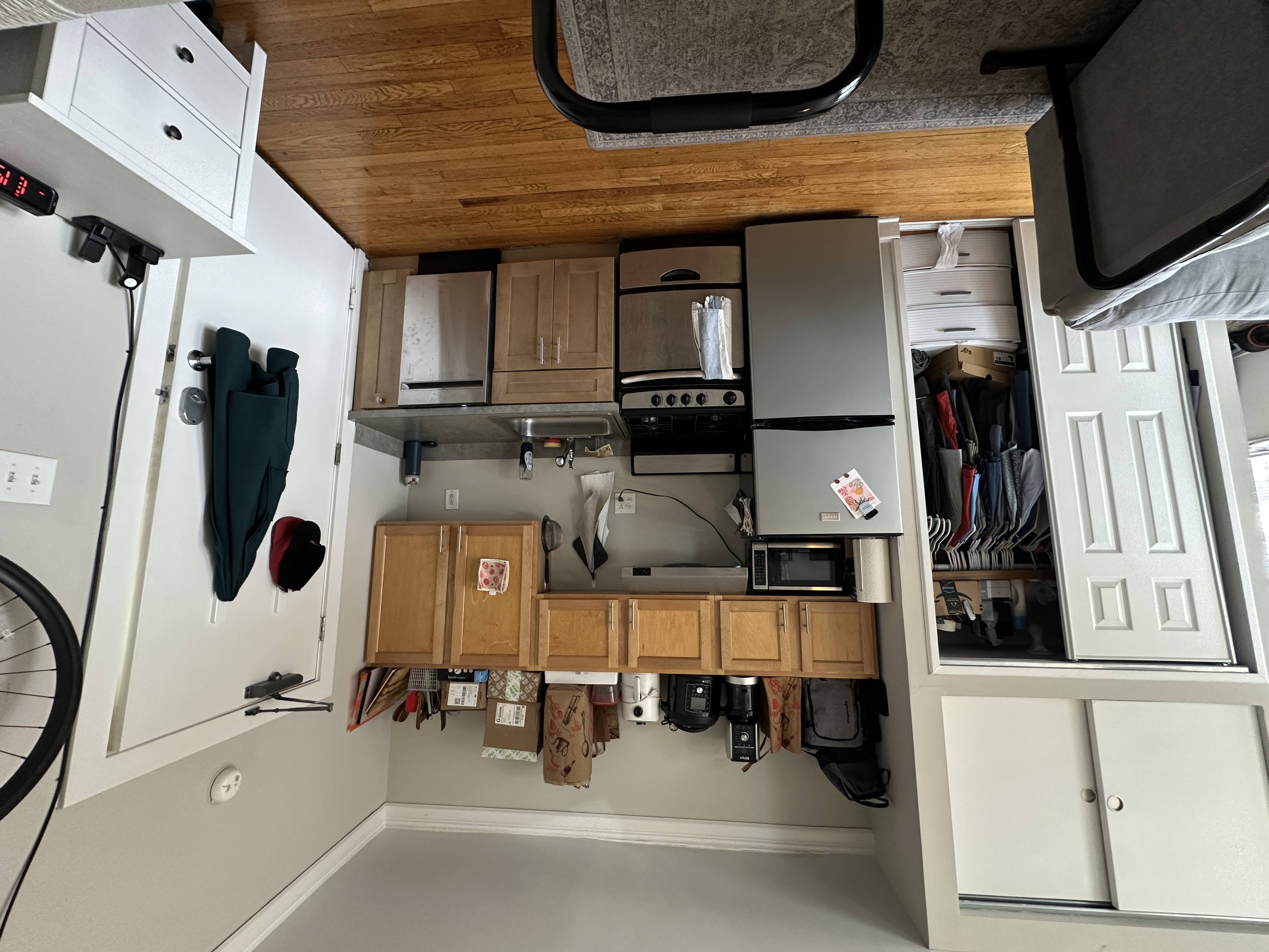 A small kitchen with a microwave, oven, and refrigerator.
