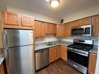 a kitchen with granite countertops and stainless steel appliances