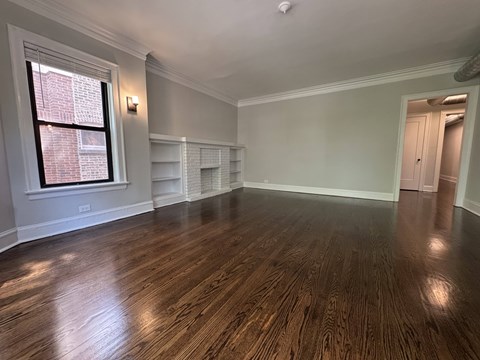 A room with wooden floors and a window.